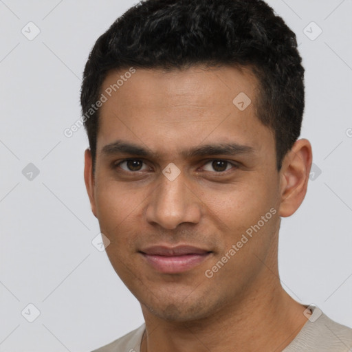 Joyful white young-adult male with short  black hair and brown eyes