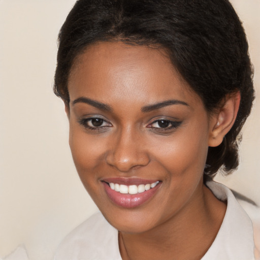 Joyful black young-adult female with long  brown hair and brown eyes