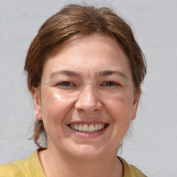 Joyful white adult female with medium  brown hair and brown eyes