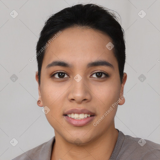 Joyful latino young-adult female with short  black hair and brown eyes