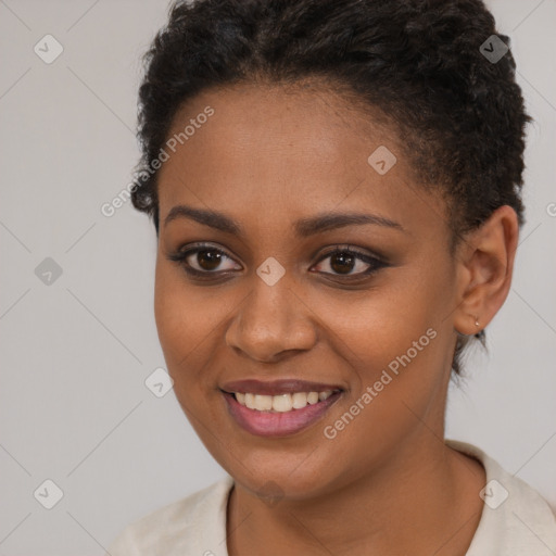 Joyful black young-adult female with short  brown hair and brown eyes