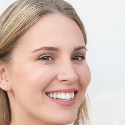 Joyful white young-adult female with long  brown hair and grey eyes