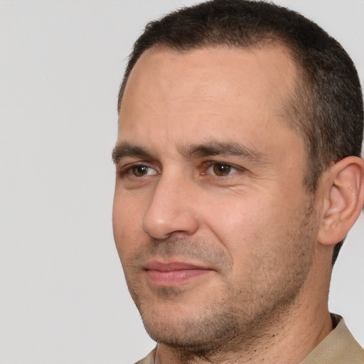 Joyful white adult male with short  brown hair and brown eyes