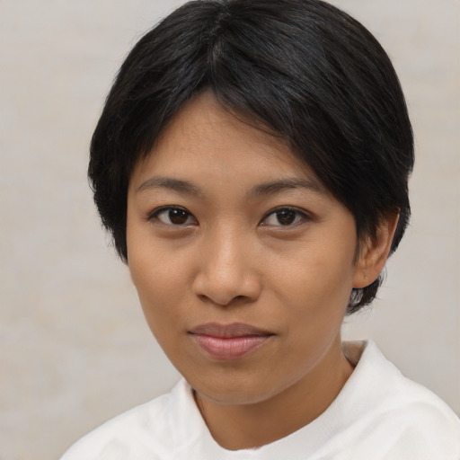 Joyful asian young-adult female with short  black hair and brown eyes