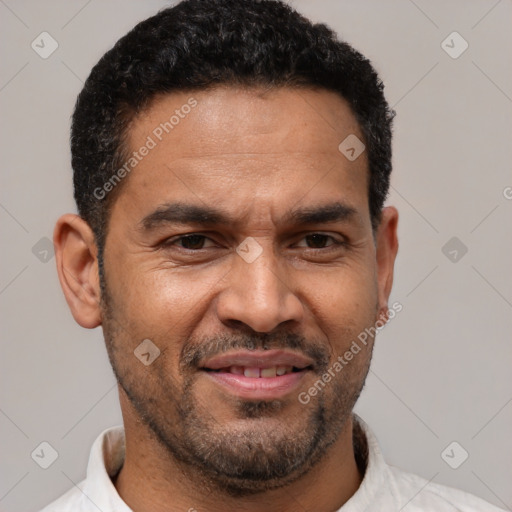 Joyful latino adult male with short  brown hair and brown eyes