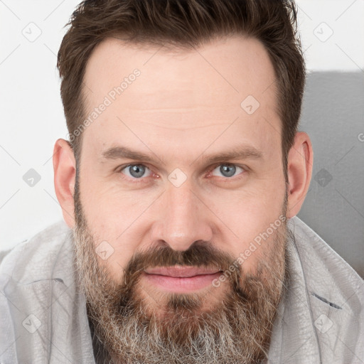 Joyful white adult male with short  brown hair and grey eyes