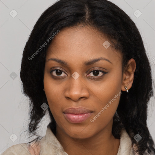 Joyful black young-adult female with long  black hair and brown eyes