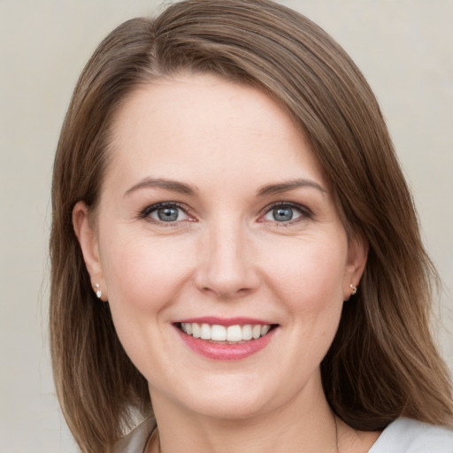 Joyful white young-adult female with medium  brown hair and green eyes