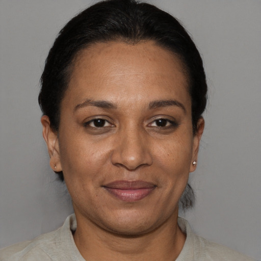 Joyful black adult female with short  brown hair and brown eyes