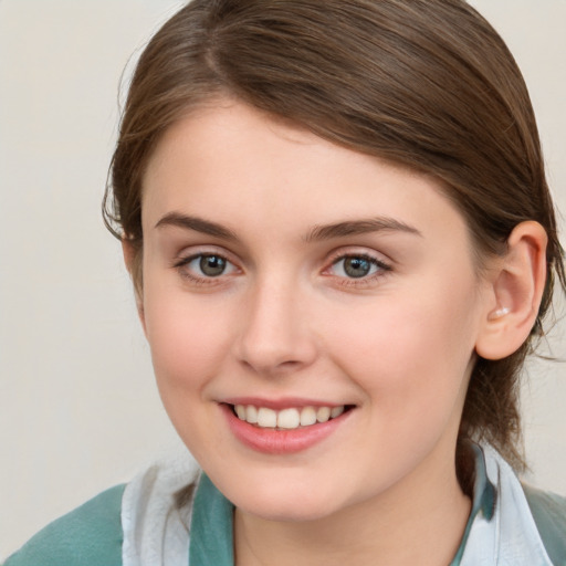 Joyful white young-adult female with medium  brown hair and blue eyes