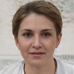 Joyful white adult female with short  brown hair and grey eyes