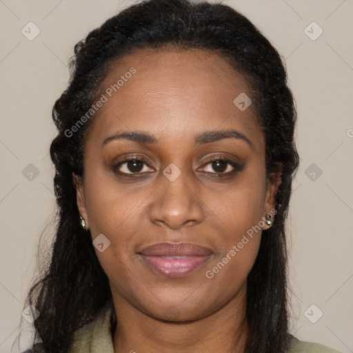 Joyful black young-adult female with long  brown hair and brown eyes