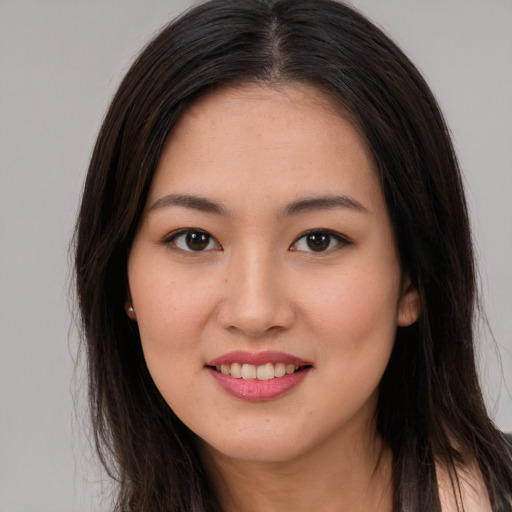 Joyful asian young-adult female with long  brown hair and brown eyes