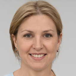 Joyful white adult female with medium  brown hair and grey eyes