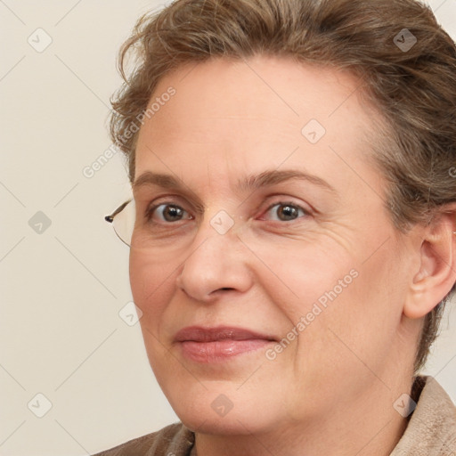 Joyful white adult female with medium  brown hair and blue eyes