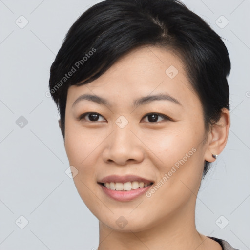 Joyful asian young-adult female with short  black hair and brown eyes