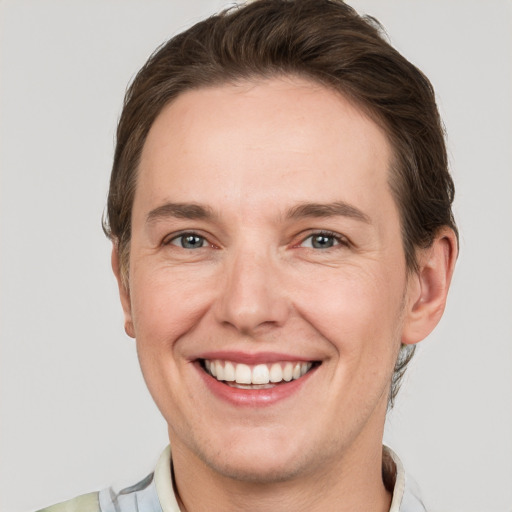 Joyful white adult male with short  brown hair and grey eyes