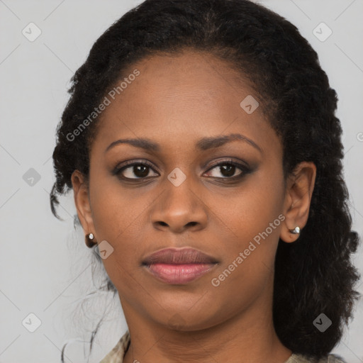 Joyful black young-adult female with long  brown hair and brown eyes