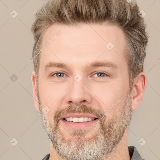 Joyful white adult male with short  brown hair and grey eyes