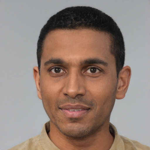 Joyful black young-adult male with short  black hair and brown eyes