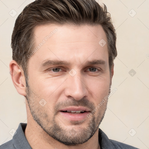 Joyful white adult male with short  brown hair and grey eyes