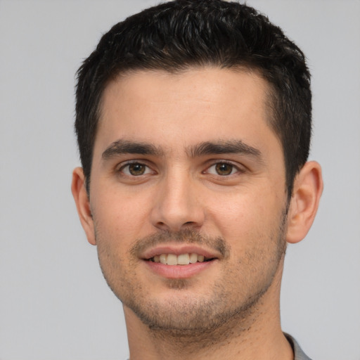 Joyful white young-adult male with short  brown hair and brown eyes