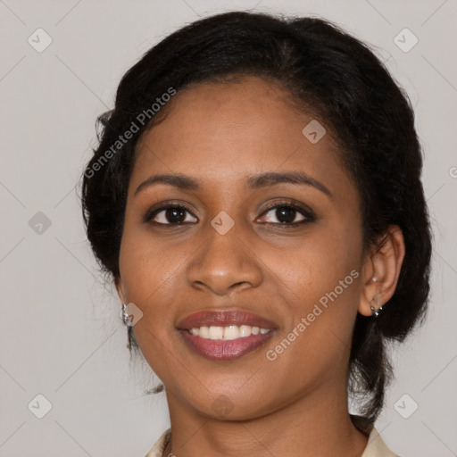 Joyful black young-adult female with long  brown hair and brown eyes