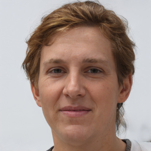 Joyful white adult female with short  brown hair and grey eyes