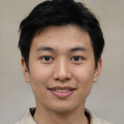 Joyful asian young-adult male with short  brown hair and brown eyes