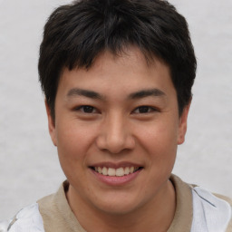 Joyful asian young-adult male with short  brown hair and brown eyes