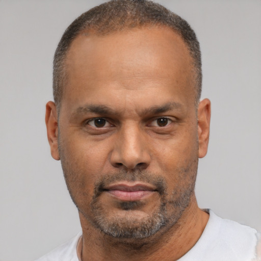 Neutral latino adult male with short  black hair and brown eyes