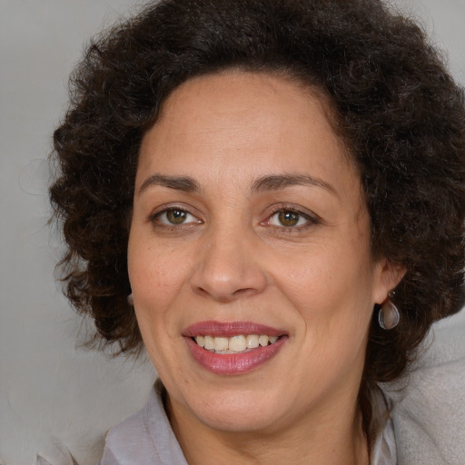 Joyful black adult female with medium  brown hair and brown eyes