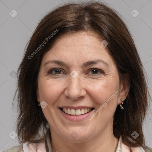 Joyful white adult female with medium  brown hair and brown eyes