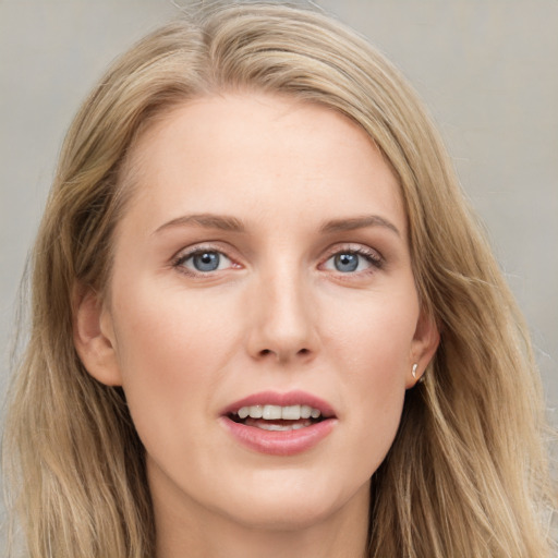 Joyful white young-adult female with long  brown hair and blue eyes