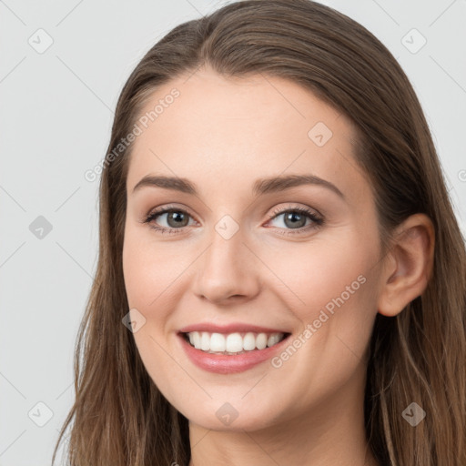 Joyful white young-adult female with long  brown hair and grey eyes