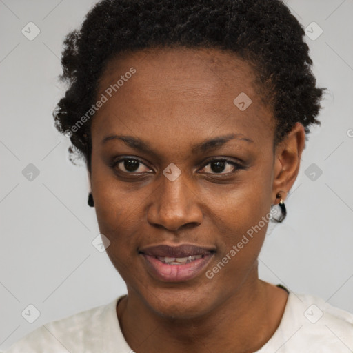 Joyful black young-adult female with short  black hair and brown eyes