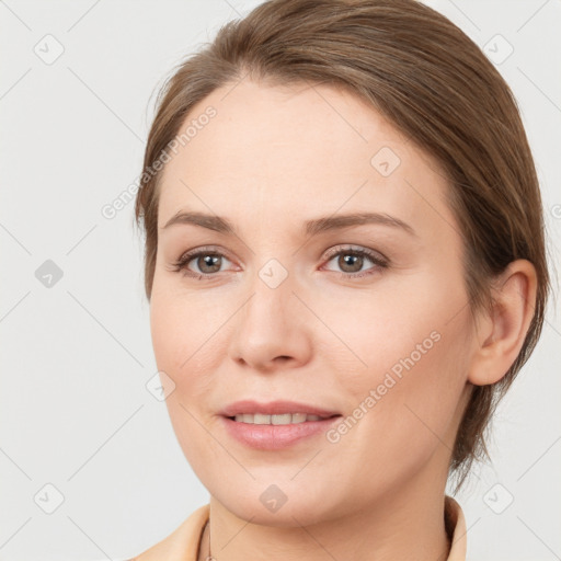 Joyful white young-adult female with medium  brown hair and grey eyes