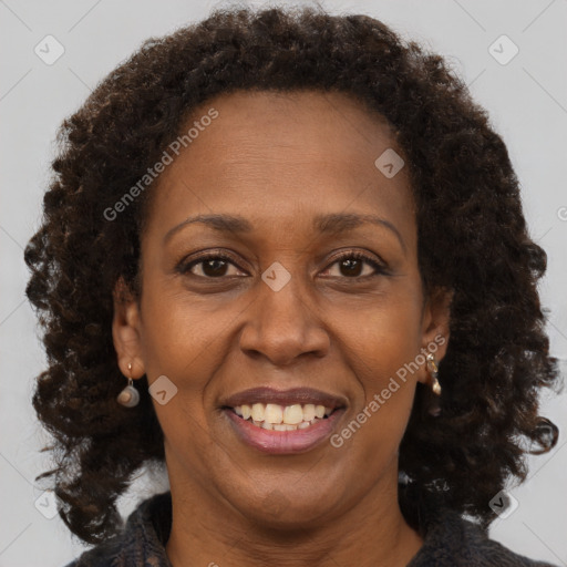 Joyful black adult female with medium  brown hair and brown eyes