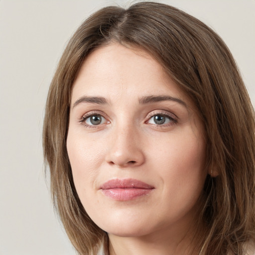 Joyful white young-adult female with long  brown hair and green eyes