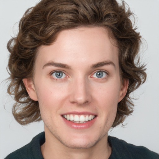 Joyful white young-adult female with medium  brown hair and blue eyes