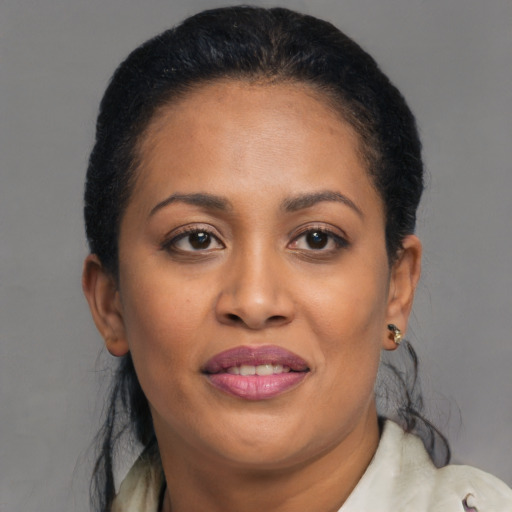 Joyful black adult female with medium  brown hair and brown eyes