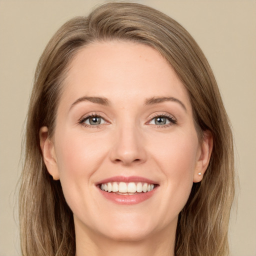 Joyful white adult female with long  brown hair and green eyes