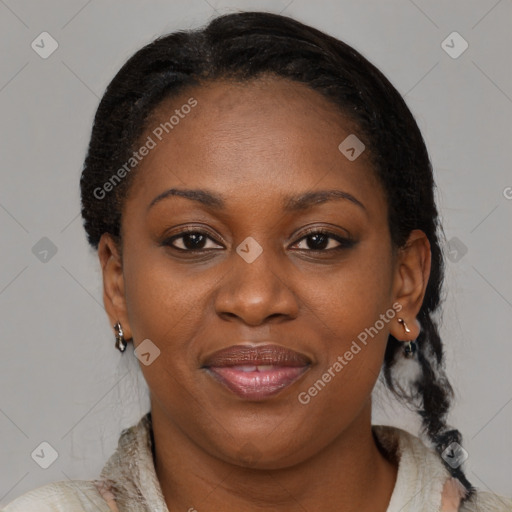 Joyful black adult female with medium  brown hair and brown eyes