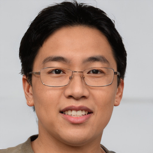 Joyful asian adult male with short  brown hair and brown eyes