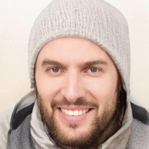 Joyful white young-adult male with short  black hair and blue eyes