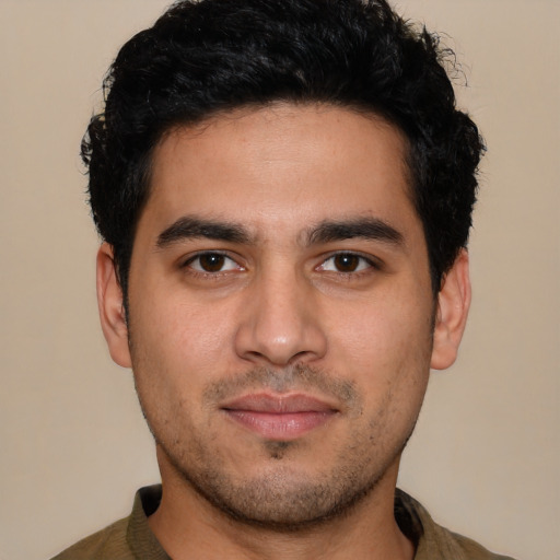 Joyful white young-adult male with short  black hair and brown eyes