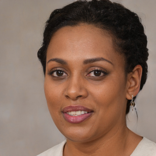 Joyful black young-adult female with short  brown hair and brown eyes