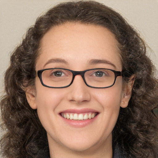 Joyful white adult female with long  brown hair and brown eyes