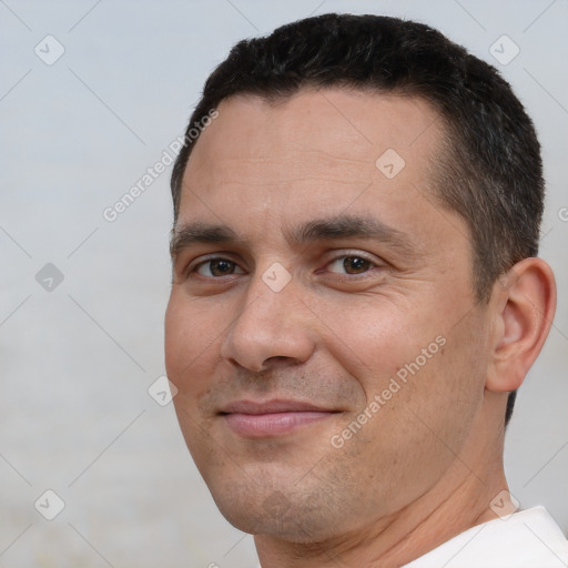 Joyful white adult male with short  brown hair and brown eyes