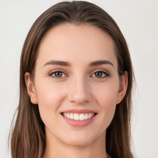 Joyful white young-adult female with long  brown hair and grey eyes